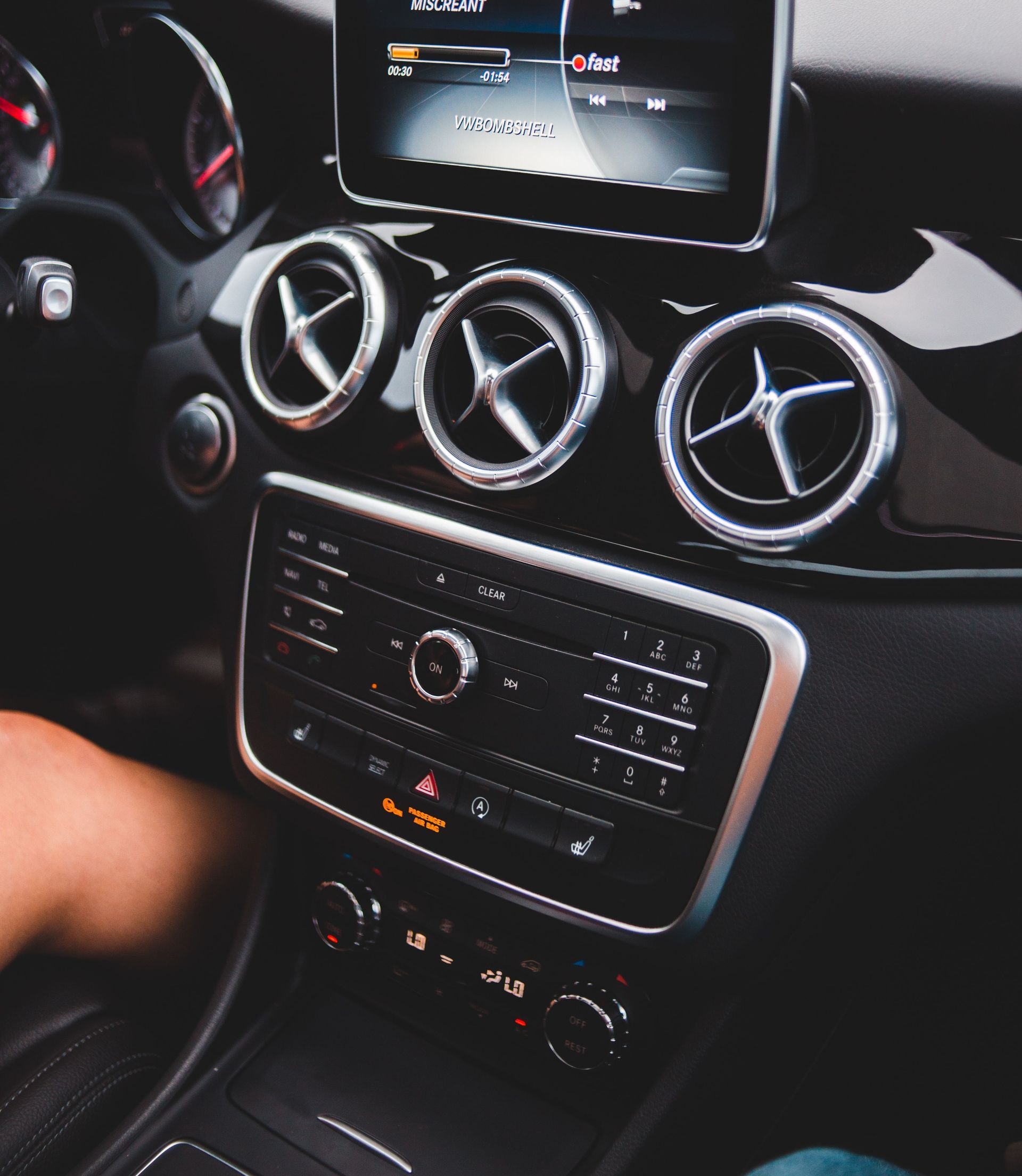 Small black touchpad and loud speakers of modern multimedia player in cabin of automobile
